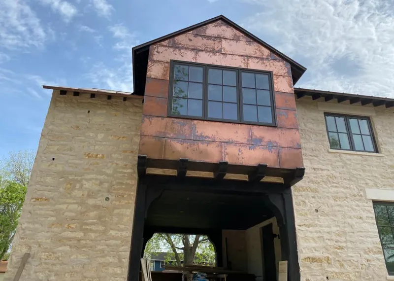 Copper metal panel facade on a stone building for Metal Roof Coating in Mill Creek East